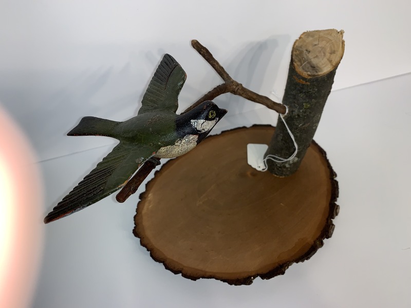 Folk Art carved bird on a branch.