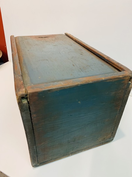 Slide lid storage box made of softwood.