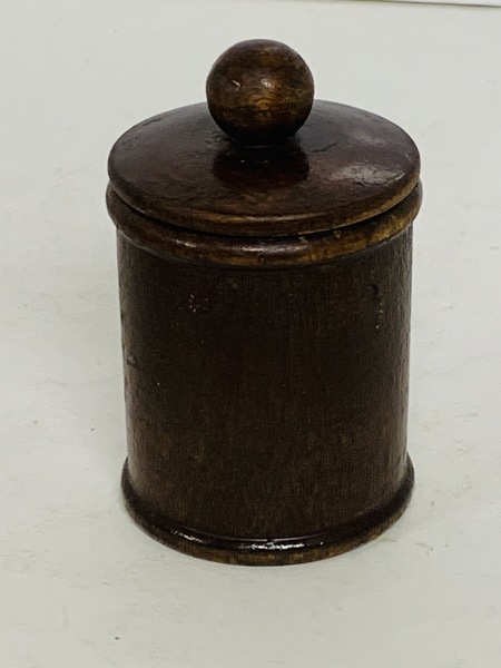 A Small round, turned wooden jar with lid