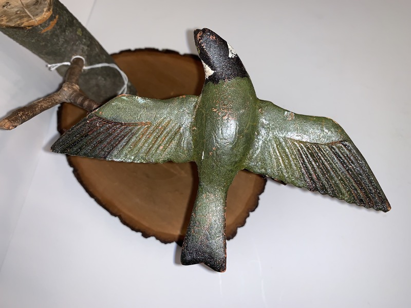 Folk Art carved bird on a branch.