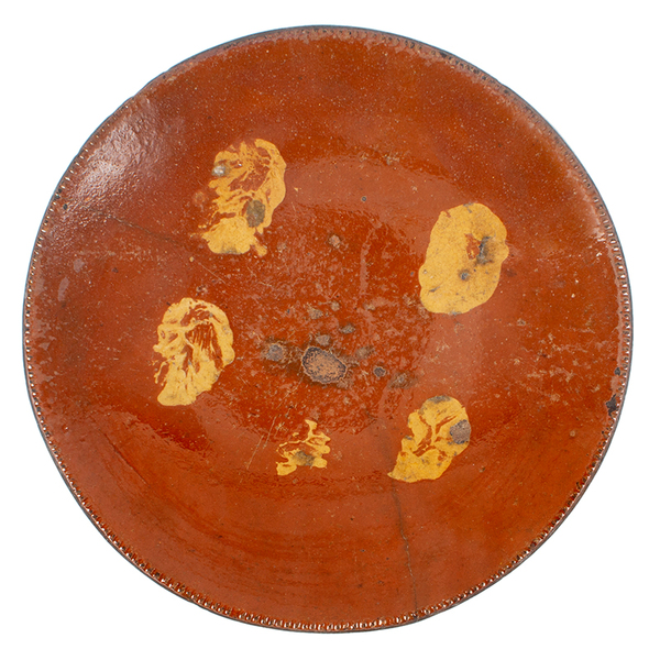 Slip decorated redware plate