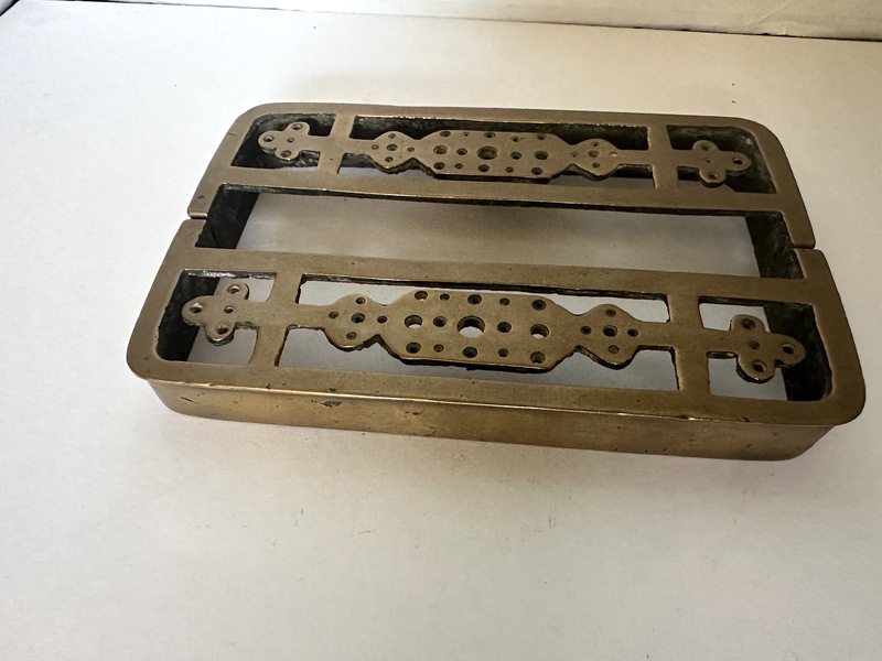 An Early Two Piece Brass Trivet to Extend to Size